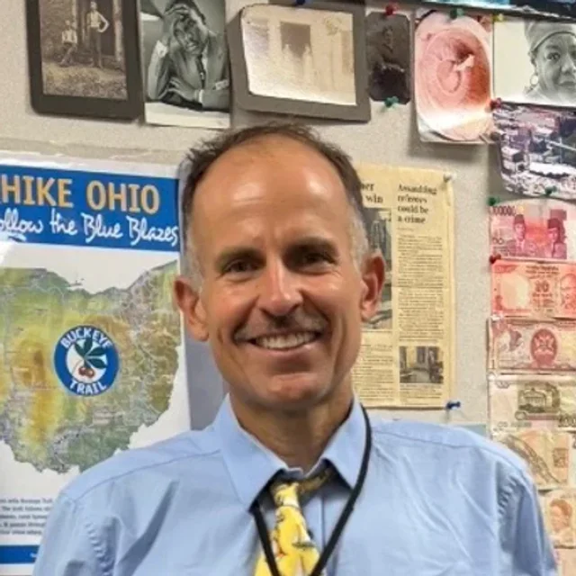 Harvey Lewis standing in his classroom